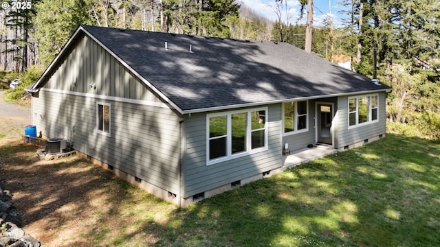 exterior space featuring crawl space, a shingled roof, a yard, and central air condition unit