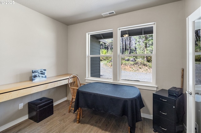 office featuring wood finished floors, visible vents, and baseboards