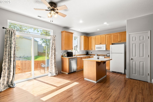 5908 SE 15th Dr, Gresham, OR 97080 - kitchen featuring white appliances, wood finished floors, light countertops, a sink, and recessed lighting