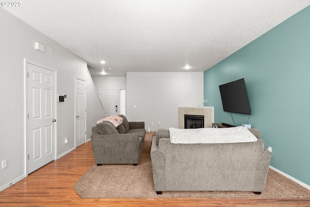 5908 SE 15th Dr, Gresham, OR 97080 - living area with a fireplace, a textured ceiling, recessed lighting, baseboards, and light wood finished floors