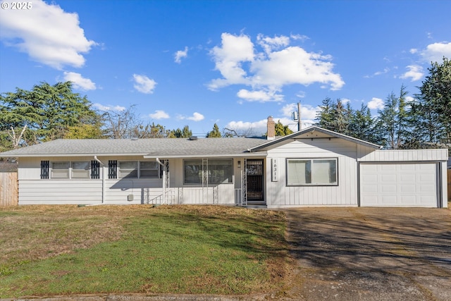 single story home featuring a garage and a front yard