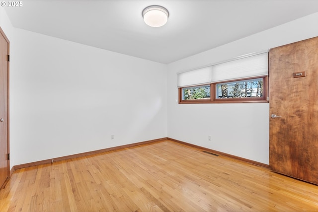 unfurnished room featuring light hardwood / wood-style floors