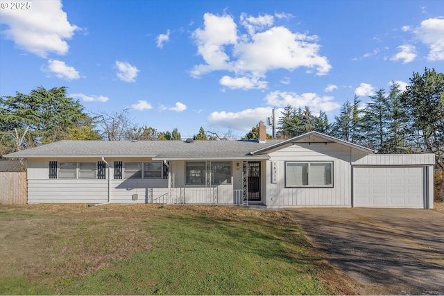 ranch-style house with a garage and a front lawn