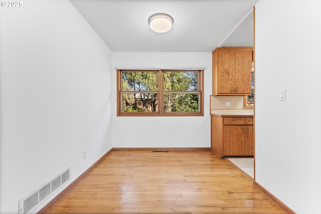 unfurnished dining area featuring light hardwood / wood-style floors