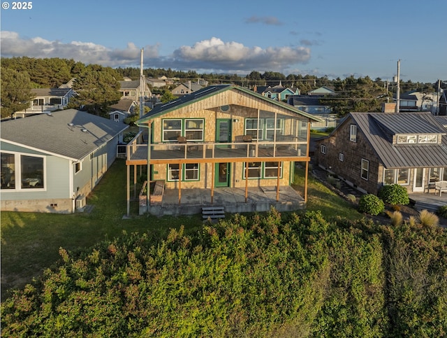 962 SW Waziyata Ave, Waldport, OR 97394 - rear view of house featuring a residential view, a deck, a lawn, and a patio