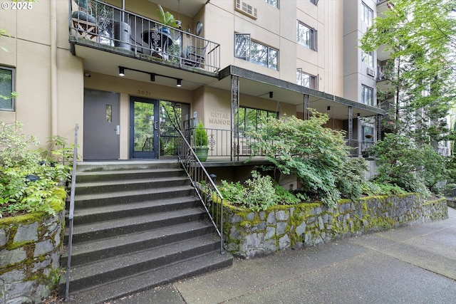 entrance to property featuring stucco siding