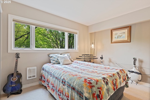 bedroom featuring baseboards, heating unit, multiple windows, and carpet