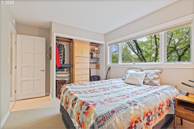 bedroom featuring a closet and light carpet