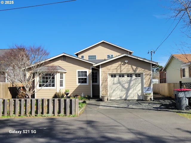 2525 Pine St, Seaside, OR 97138 - view of front of house with asphalt driveway, fence, and a garage