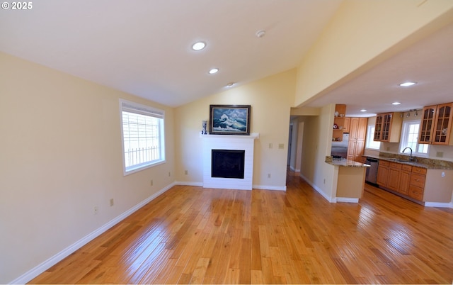 2525 Pine St, Seaside, OR 97138 - unfurnished living room with a sink, a fireplace, light wood-style floors, recessed lighting, and healthy amount of natural light