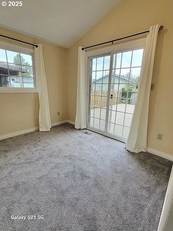 2525 Pine St, Seaside, OR 97138 - empty room with lofted ceiling, baseboards, and carpet