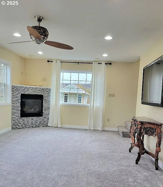 2525 Pine St, Seaside, OR 97138 - unfurnished living room with carpet floors, a ceiling fan, baseboards, recessed lighting, and a glass covered fireplace