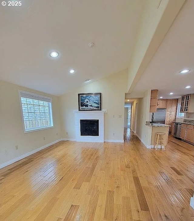 2525 Pine St, Seaside, OR 97138 - unfurnished living room featuring a fireplace, light wood-style floors, lofted ceiling, recessed lighting, and baseboards