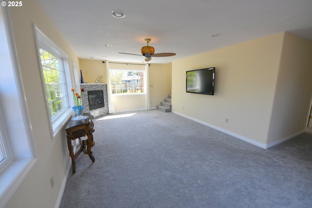 2525 Pine St, Seaside, OR 97138 - carpeted living room featuring a glass covered fireplace, baseboards, ceiling fan, stairway, and recessed lighting
