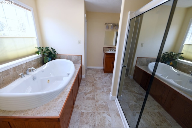 2525 Pine St, Seaside, OR 97138 - full bathroom with a jetted tub, vanity, a stall shower, and baseboards