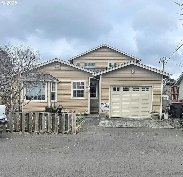 2525 Pine St, Seaside, OR 97138 - view of front of home featuring fence, an attached garage, and asphalt driveway
