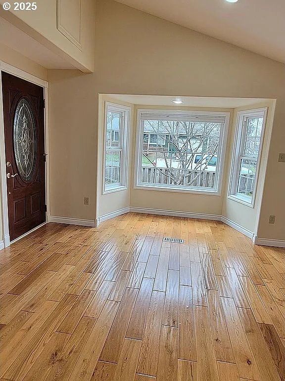 2525 Pine St, Seaside, OR 97138 - foyer with light wood-style flooring, baseboards, and vaulted ceiling