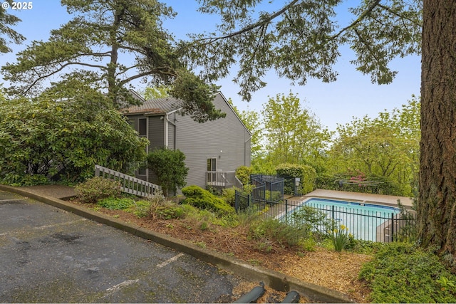 view of swimming pool featuring a fenced in pool and fence