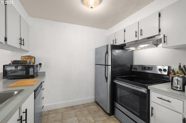 kitchen featuring under cabinet range hood, baseboards, light countertops, white cabinets, and appliances with stainless steel finishes