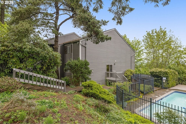 view of property exterior featuring a fenced backyard and a fenced in pool