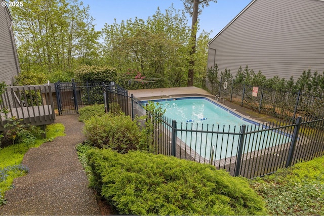 view of pool with a fenced in pool and fence