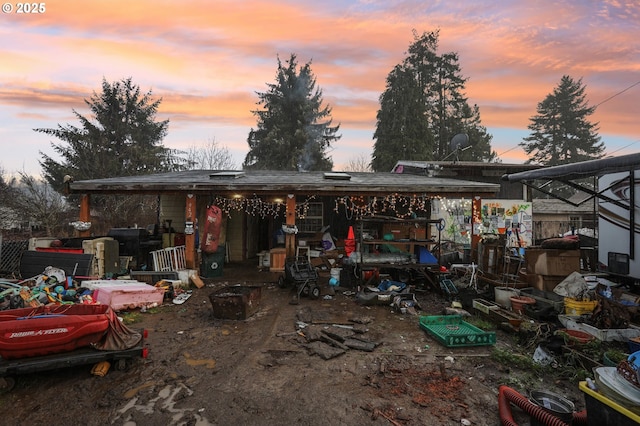 view of back house at dusk