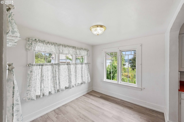 2479 Sherman Ave, North Bend, OR 97459 - unfurnished room with wood finished floors, baseboards, and arched walkways