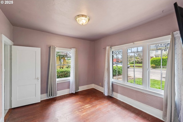 2479 Sherman Ave, North Bend, OR 97459 - spare room featuring dark wood-style flooring, plenty of natural light, and baseboards