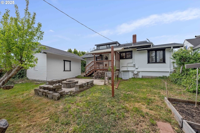 2479 Sherman Ave, North Bend, OR 97459 - rear view of property with a fire pit, a garden, a yard, a chimney, and a deck