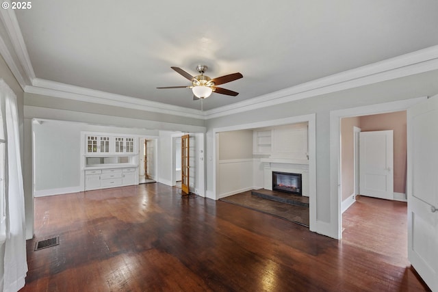 2479 Sherman Ave, North Bend, OR 97459 - unfurnished living room with a ceiling fan, crown molding, wood finished floors, baseboards, and a glass covered fireplace