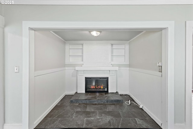 2479 Sherman Ave, North Bend, OR 97459 - detailed view of a glass covered fireplace, built in features, and a wainscoted wall