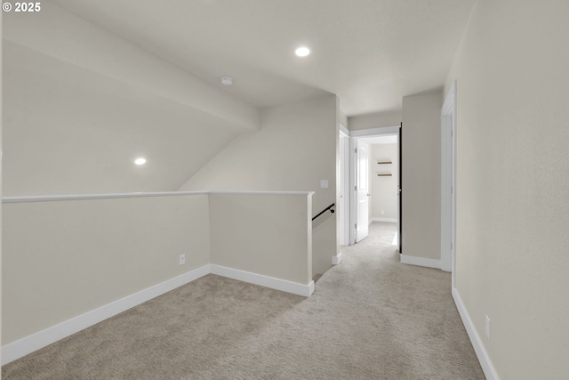 hallway with light carpet, recessed lighting, an upstairs landing, and baseboards