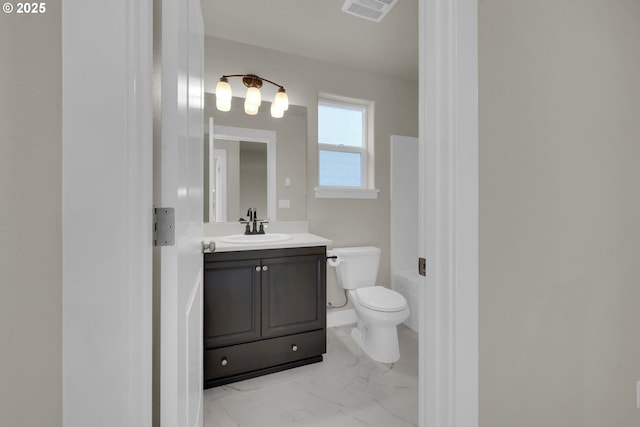 full bath featuring toilet, a washtub, visible vents, vanity, and marble finish floor