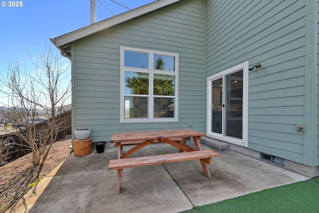 exterior space with a patio area, fence, and outdoor dining area