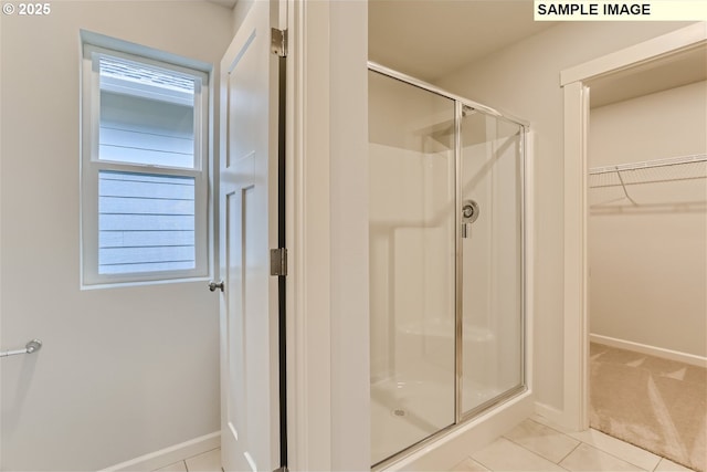 949 Legacy St, Eugene, OR 97402 - bathroom with a stall shower, a spacious closet, and tile patterned flooring