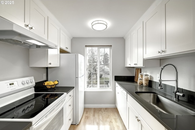 kitchen featuring white cabinetry, sink, white appliances, and light wood-type flooring