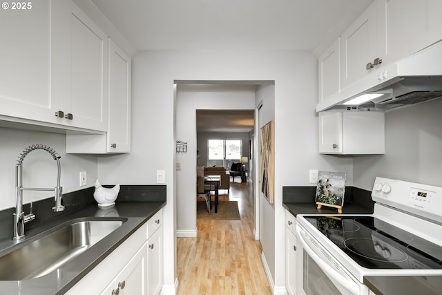 kitchen with white cabinets, light hardwood / wood-style floors, sink, and electric range