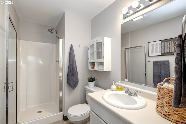 bathroom with an enclosed shower, vanity, and toilet