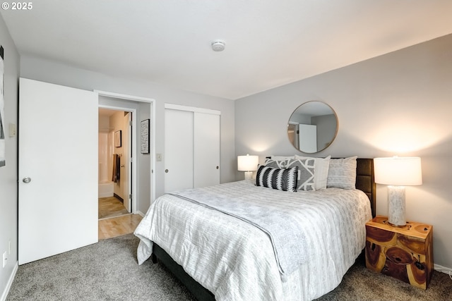 carpeted bedroom featuring ensuite bath and a closet