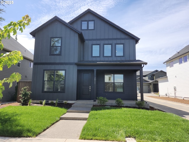 2911 Olympic St Unit 25, Woodburn, OR 97071 - view of front facade featuring a porch, board and batten siding, a front lawn, and roof with shingles