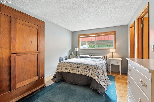 2112 SE 148th Pl, Portland, OR 97233 - bedroom with light wood-style floors and a textured ceiling