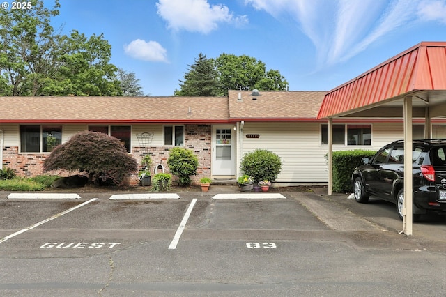 2112 SE 148th Pl, Portland, OR 97233 - view of front facade with uncovered parking, brick siding, and roof with shingles