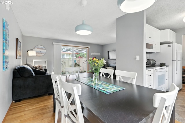 2112 SE 148th Pl, Portland, OR 97233 - dining area featuring a textured ceiling and light wood-style flooring