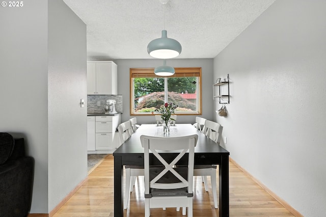 2112 SE 148th Pl, Portland, OR 97233 - dining space with light wood-style floors and a textured ceiling