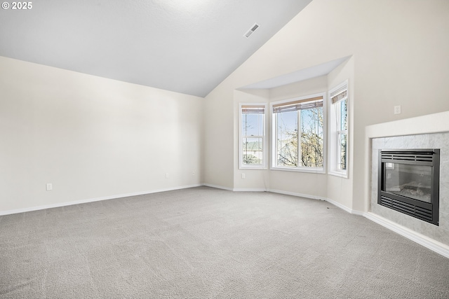 unfurnished living room featuring visible vents, baseboards, carpet, a fireplace, and high vaulted ceiling