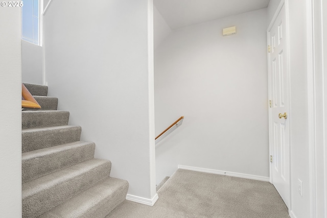 stairs with carpet floors and baseboards