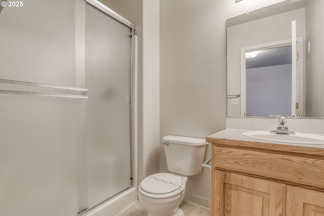 full bathroom with toilet, vanity, and a shower stall