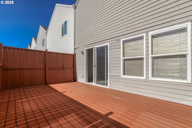 wooden terrace featuring fence