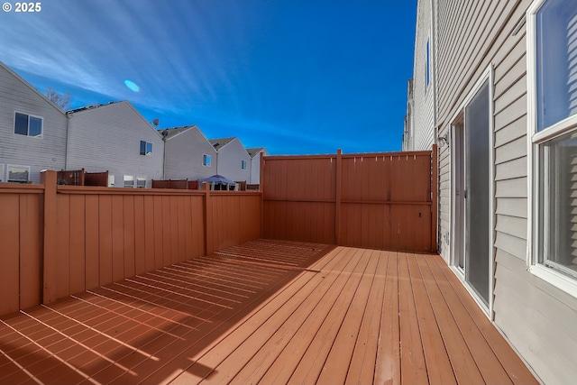 wooden terrace with fence and a residential view