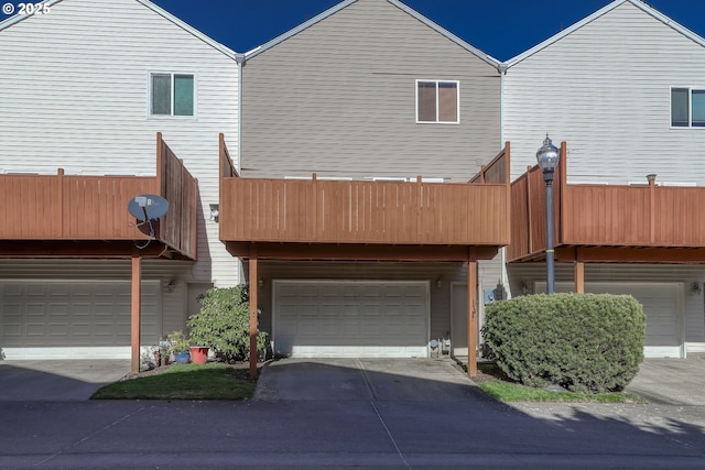 view of front facade featuring a garage and a balcony